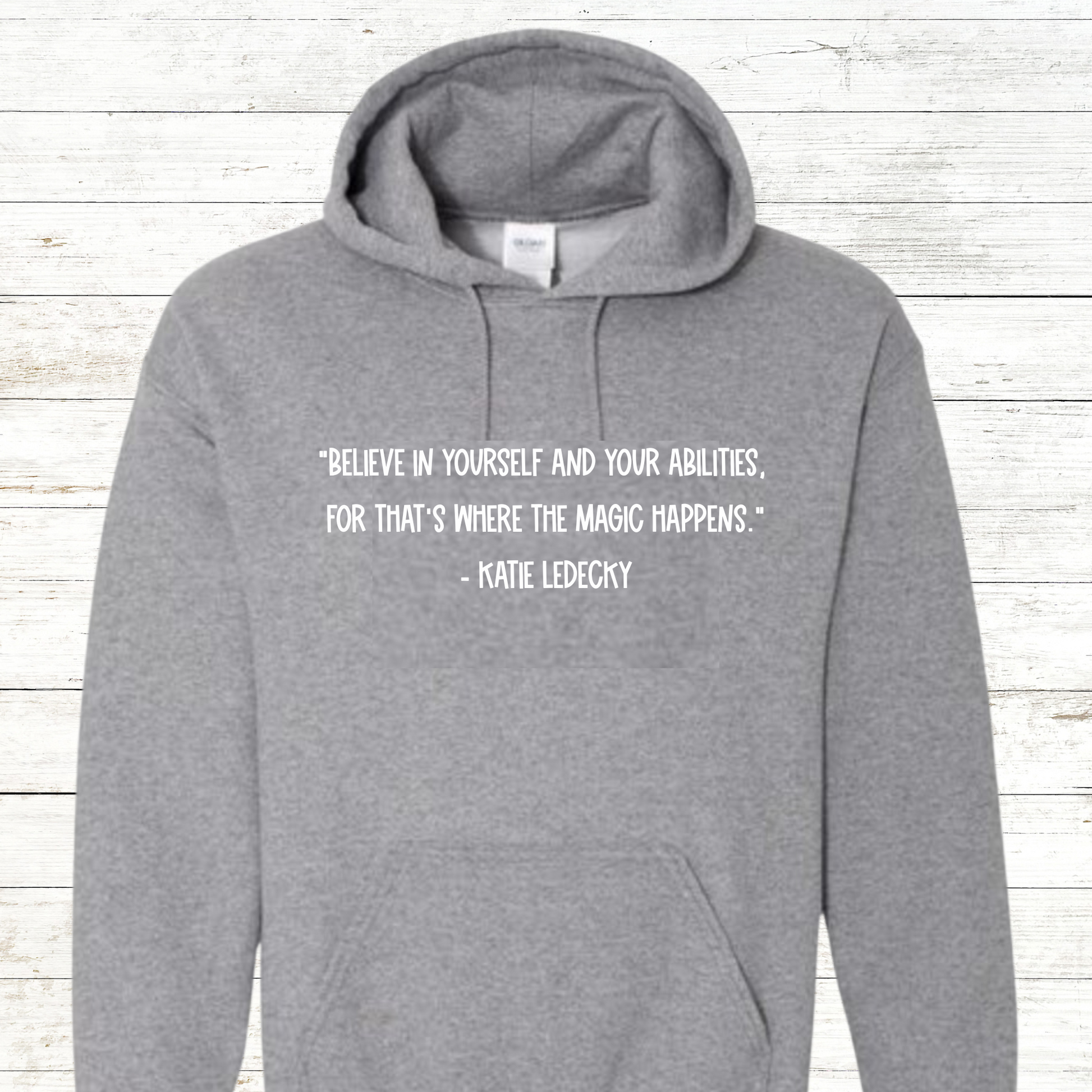 Inspirational swimming shirt or sweatshirt featuring a Katie Ledecky quote. Available in unisex sizes for youth and adults, perfect for swimmers, swim teams, and coaches. A motivational gift for competitive athletes and swim enthusiasts.
