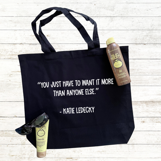 Black tote bag featuring an inspirational swimmer quote, perfect for swim enthusiasts. The design motivates and inspires swimmers with its uplifting message, making it a great accessory for practice, meets, or everyday use. Spacious and durable, this tote is ideal for carrying swim gear, personal items, or even a quick snack after a hard workout. A must-have for anyone passionate about swimming and staying motivated!