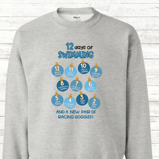 A festive "12 Days of Swimming - Christmas Edition" shirt featuring a fun holiday design with swimming-themed elements. Available in shirts and sweatshirts, perfect for celebrating the season with a splash.